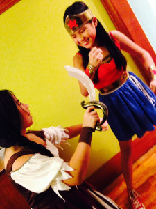 Two of my children, a.k.a. store-bought Pirate and handmade Wonder Woman, in a battle for costume supremacy 